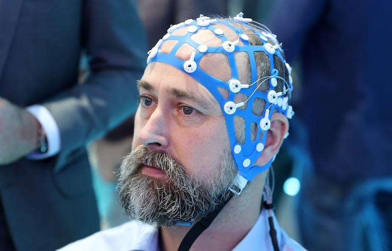 Tue Lehn-Schioler, chief executive of BrainCapture wearing the device which helps to diagnose epilepsy and other neuro problems at the Arab Health conference held at Dubai World Trade Centre. Pictures: Pawan Singh / The National
