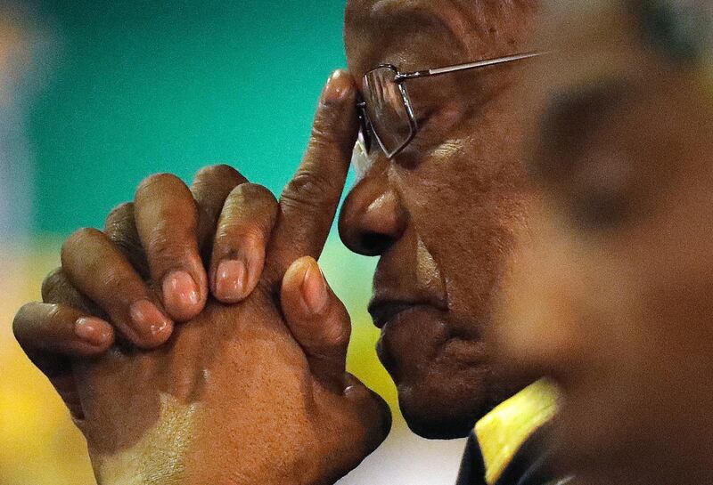 FILE - In this Thursday, Dec. 21, 2017, file photo of former South African Jacob Zuma, gestures as a new party leader addresses delegates during the closing of the ANC's elective conference in Johannesburg. The director of South Africa's National Prosecuting Authority says that former president Jacob Zuma will be prosecuted on 16 charges of corruption. Shaun Abrahams announced Friday that Zuma will be face charges including fraud, corruption, racketeering and money laundering. (AP Photo/Themba Hadebe, File)