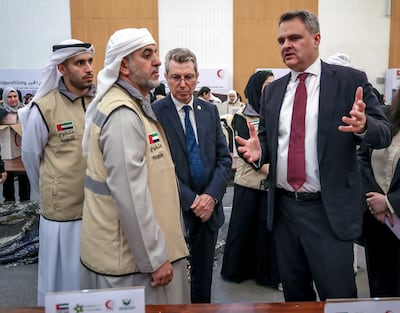 Tugay Tuncer (R), with Emirates Red Crescent chairman Dr Hamdan Al Mazrouei, said Turkey was thankful for the UAE's support. Victor Besa / The National