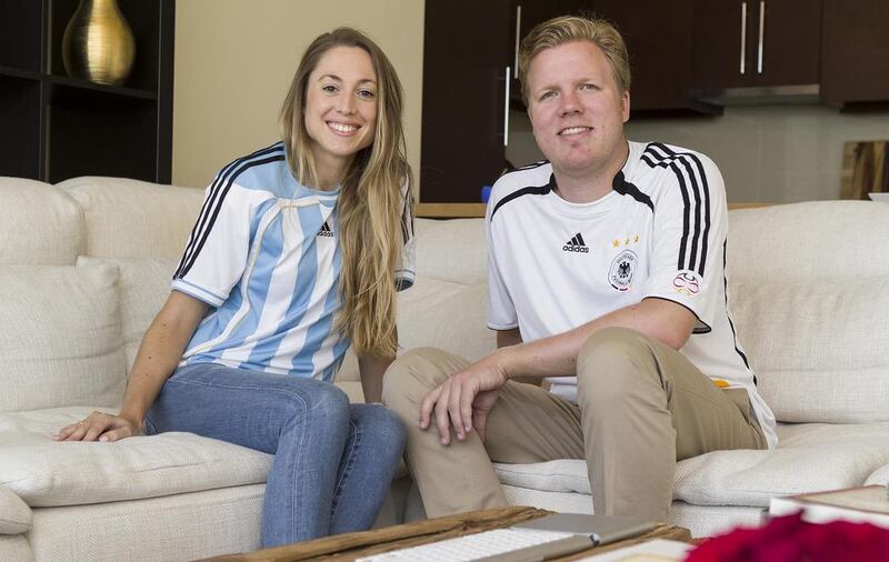 Sebastian and Karin Haase in their German and Argentinian football shirts at their home on the Corniche in Abu Dhabi. Mrs Haase said although her husband said he would be happy if Argentina won, he was “90 per cent for Germany and 10 pr cent for Argentina”. Antonie Robertson / The National