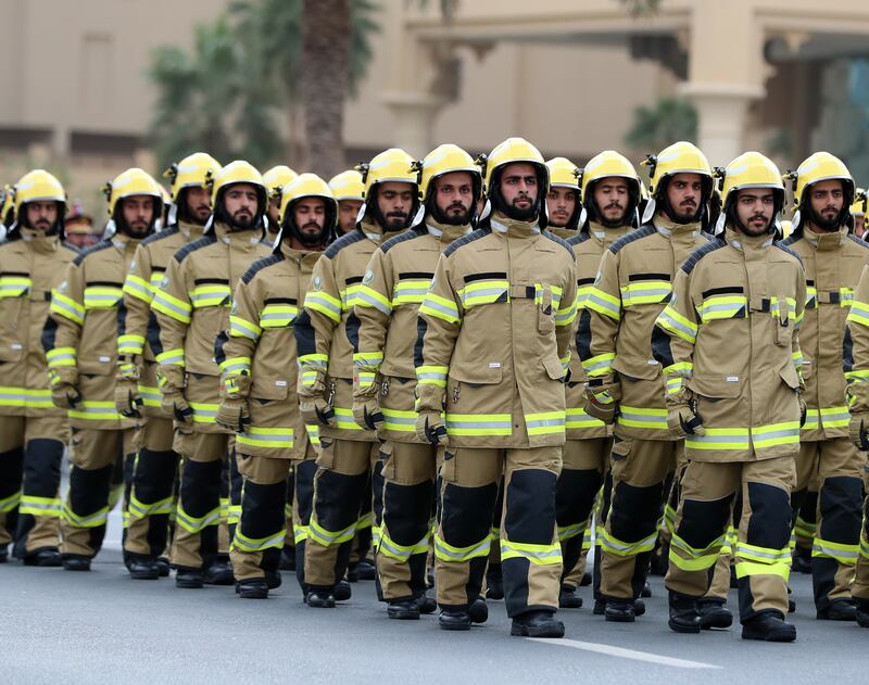 Civil defence officers take part in a march.