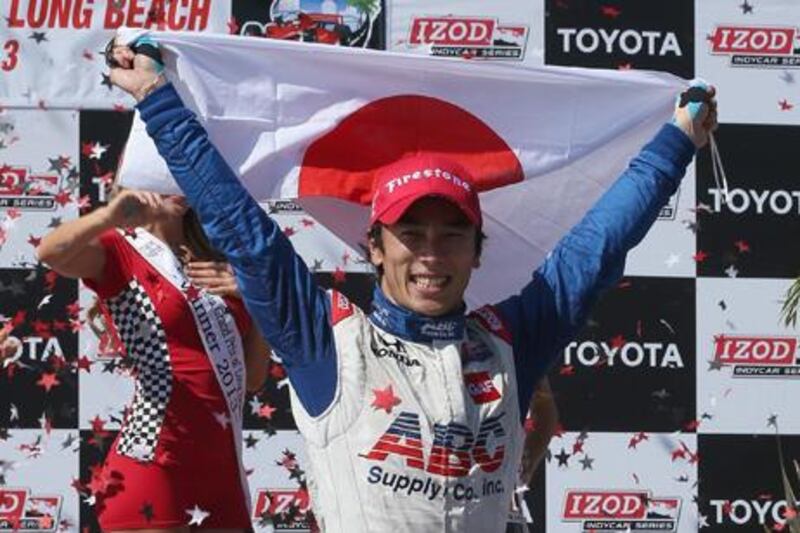 IndyCar driver Takuma Sato celebrates his victory for AJ Foyt Racing at the Long Beach Grand Prix.