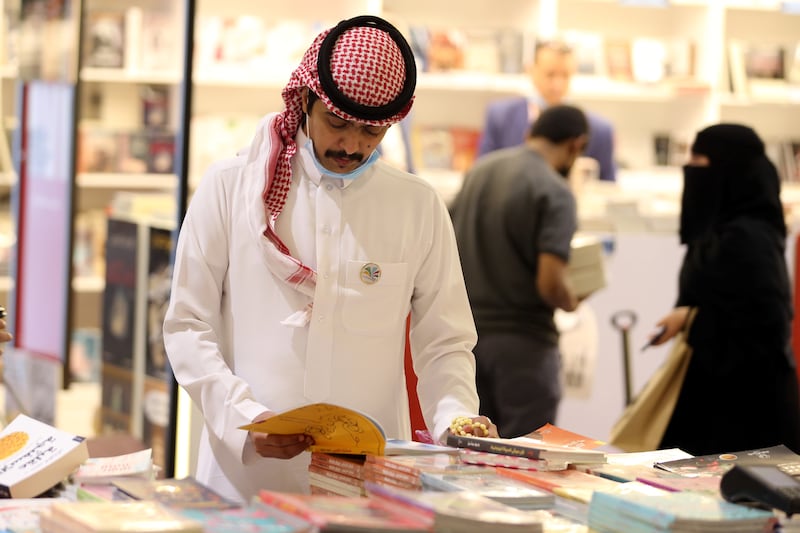 A Saudi man peruses a book at the Riyadh International Book Fair