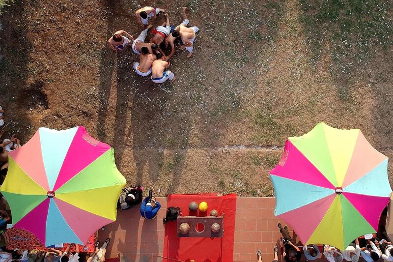 Vietnamese men wrestling for the prized jackfruit wooden ball during the traditional "Vat Cau" or ball wrestling festival in Hanoi. AFP