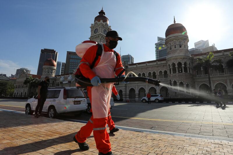 A worker sprays disinfectant at Independence Square during a disinfection operation in Kuala Lumpur, Indonesia. Reuters