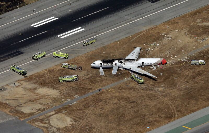 SAN FRANCISCO, CA - JULY 06: A Boeing 777 airplane lies burned on the runway after it crash landed at San Francisco International Airport July 6, 2013 in San Francisco, California. An Asiana Airlines passenger aircraft coming from Seoul, South Korea crashed while landing. There has been no official confirmation of casualties.   Ezra Shaw/Getty Images/AFP== FOR NEWSPAPERS, INTERNET, TELCOS & TELEVISION USE ONLY ==
 *** Local Caption ***  505056-01-09.jpg