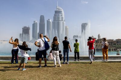 Tourists at the water fountain display near the Burj Khalifa, in Dubai. Bloomberg