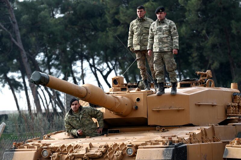 epa06459996 Turkish soldiers prepare their tanks near the Syrian-Turkish border, at Reyhanli district in Hatay, Turkey, 21 January 2018. Reports state that the Turkish army is on an operation (named 'Operation Olive Branch') in Syria's northern regions against the Kurdish Popular Protection Units (YPG) forces which control the city of Afrin. According to YPG media channels, bombings by the Turkish military killed at least 10 people earlier on the same day. Turkey classifies the YPG as a terrorist organization.  EPA/SEDAT SUNA