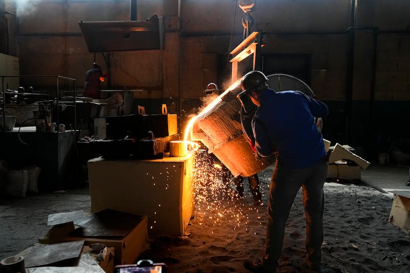 Workers pour molten steel into a mould at a foundry in Berdyansk, Zaporizhzhia region, in an area under Russian military control. AP 