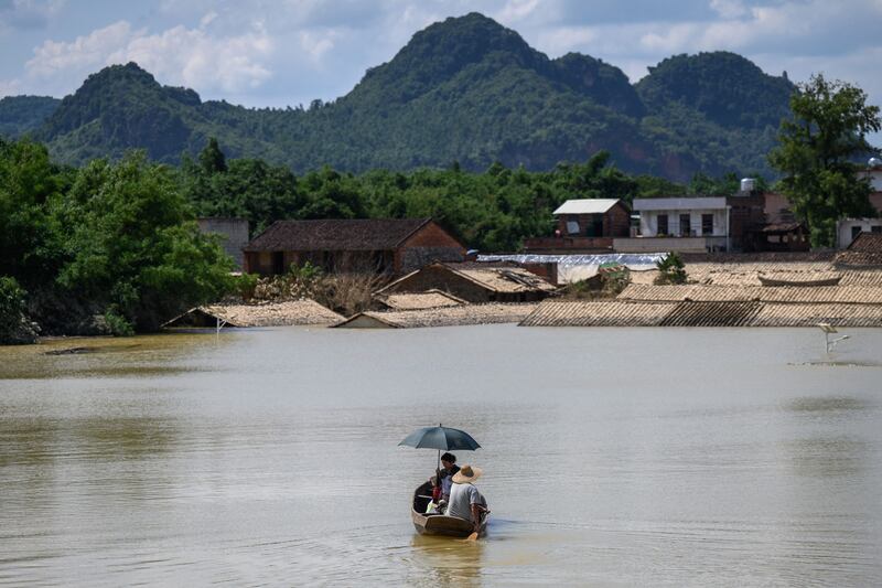 Residents on a boat in a flooded area after heavy rains in Yingde, Qingyuan city, in China's southern Guangdong province. AFP