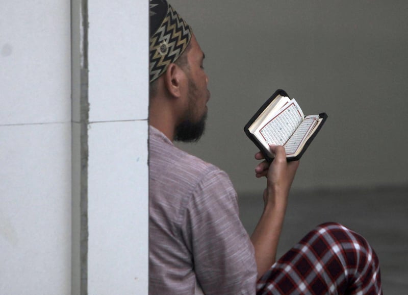 A Muslim man reads the Quran inside the Annur Mosque in Dili, East Timor. EPA