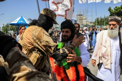 The Taliban greet Asadullah Haroon, centre, one of the two Afghans detained at Guantanamo Bay, as he arrives in Kabul, in June. EPA