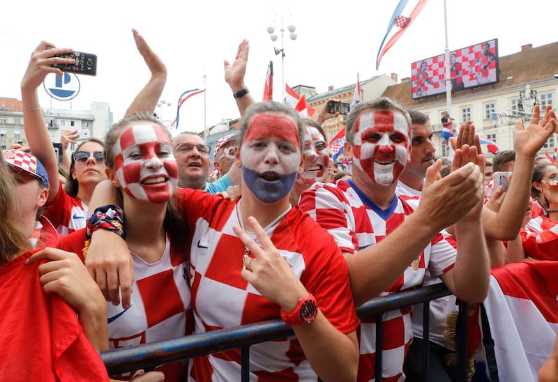 Supporters cheer while waiting for the arrival of the Croatian national football team in central Zagreb. Antonio Bat / EPA