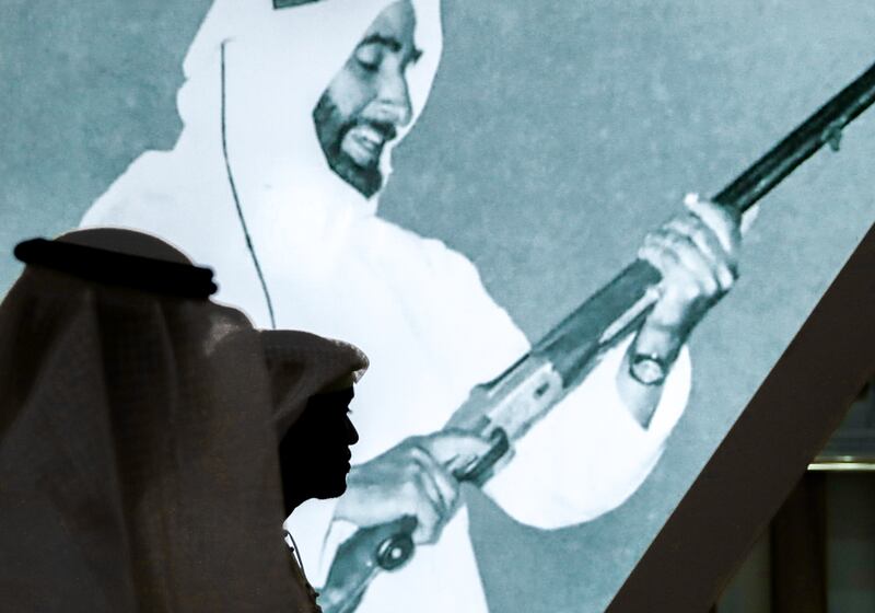 Photograph of Sheikh Zayed holding a hunting rifle on display at Adihex. Victor Besa / The National