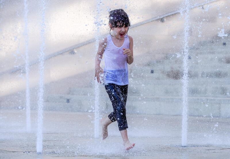 Abu Dhabi, United Arab Emirates, October 26, 2020.  The "new norm" of Covid-19 precautionary measures at Umm Al Emarat Park, Abu Dhabi, on a Monday afternoon.  Jasmine Al Sabah, 6, enjoys one of the many water fountains at the park.
Victor Besa/The National
Section:  NA
Reporter: