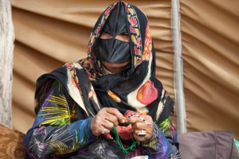 UAE - Ras Al Khaimah - Feb 02- 2011: A woman who sell crafts during the camel races festival. ( Jaime Puebla - The National Newspaper )