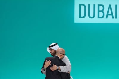Cop28 President Dr Sultan Al Jaber and UN Framework Convention on Climate Change Executive Secretary Simon Stiell embrace at the climate summit in Dubai on December 13. Renewable energy to lower carbon emissions formed a core part of last year's UAE Consensus. AFP