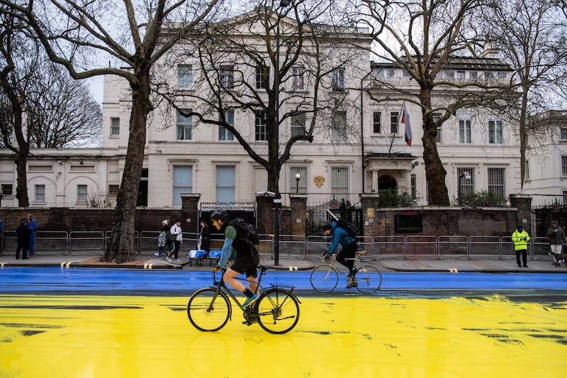 A road painted by activists to create a giant Ukrainian flag, outside the Russian embassy in London, on the eve of the anniversary. Getty Images