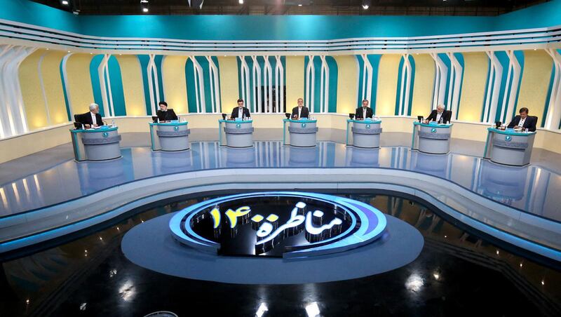 Iranian presidential candidates, Saeed Jalili, Ebrahim Raisi, Amirhossein Ghazizade, Alireza Zakani, Mohsen Rezaie, Mohsen Mehralizadeh, and Abdol Naser Hemati, during the first televised debate between Iran presidential candidates at the Iran State television studio in Tehran. AFP PHOTO /Iranian Young Journalist Club