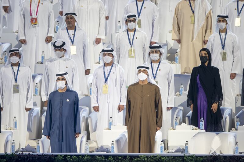 Sheikh Mohammed bin Rashid, Vice President and Ruler of Dubai, front left, Sheikh Mohamed bin Zayed, Crown Prince of Abu Dhabi and Deputy Supreme Commander of the UAE Armed Forces, front right, with members of the UAE royal families stand for the national anthem.