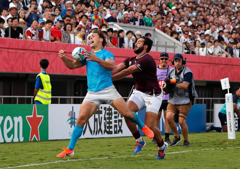 Uruguay's Nicolás Freitas, left, is challenged by Georgia's Giorgi Kveseladze at Kumagaya Rugby Stadium on Sunday. AP