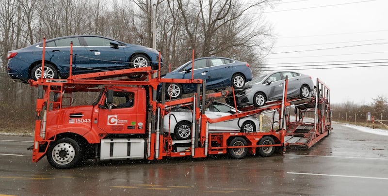 An auto transport truck full of new cars drives out of the General Motors Lordstown plant, Tuesday, Nov. 27, 2018, in Lordstown, Ohio. Even though unemployment is low, the economy is growing and U.S. auto sales are near historic highs, GM is cutting thousands of jobs in a major restructuring aimed at generating cash to spend on innovation. GM put five plants up for possible closure, including the plant in Lordstown.(AP Photo/Tony Dejak)