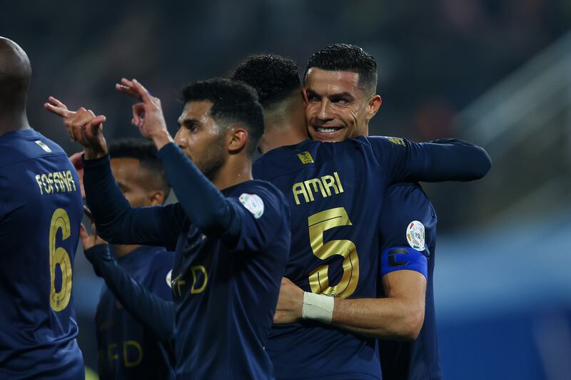 Cristiano Ronaldo is congratulated by teammates after scoring Al Nassr's fourth goal. Getty Images
