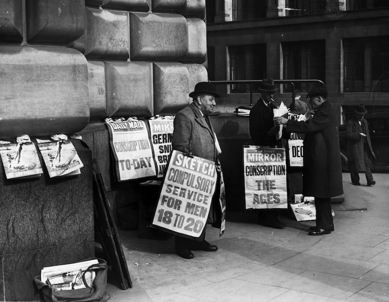 Newspaper placards in London announce the conscription of all men aged 20 and 21 into the army in 1939