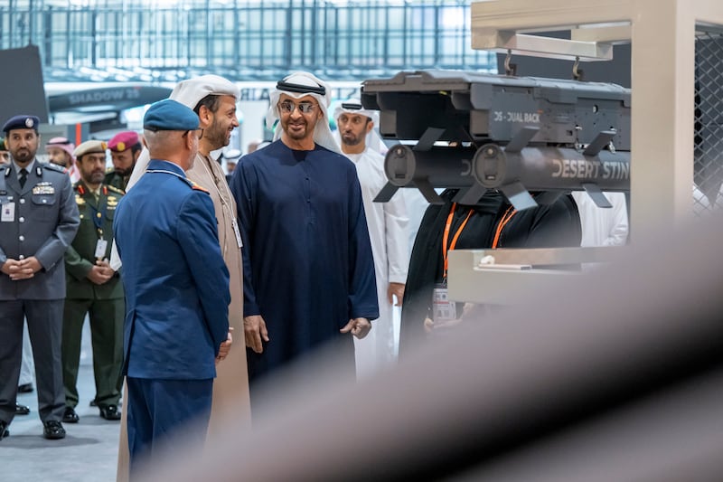 Sheikh Mohamed, Lt Gen Al Mazrouei and Mr Al Bannai review defence equipment during a tour of Idex