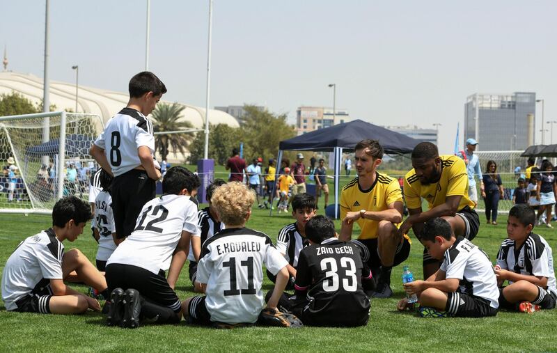 Abu Dhabi, United Arab Emirates - Juventus (white/black) vs. ESG Football Academy from Oman (green) under 12 age group on Abu Dhabi World Cup Day 1 at Zayed Sports City. Khushnum Bhandari for The National
