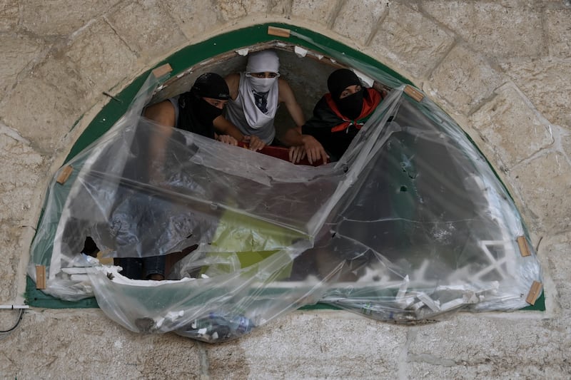 Masked Palestinians take position. The Palestinian Red Crescent emergency service said 59 wounded people were admitted to hospital.  AP Photo