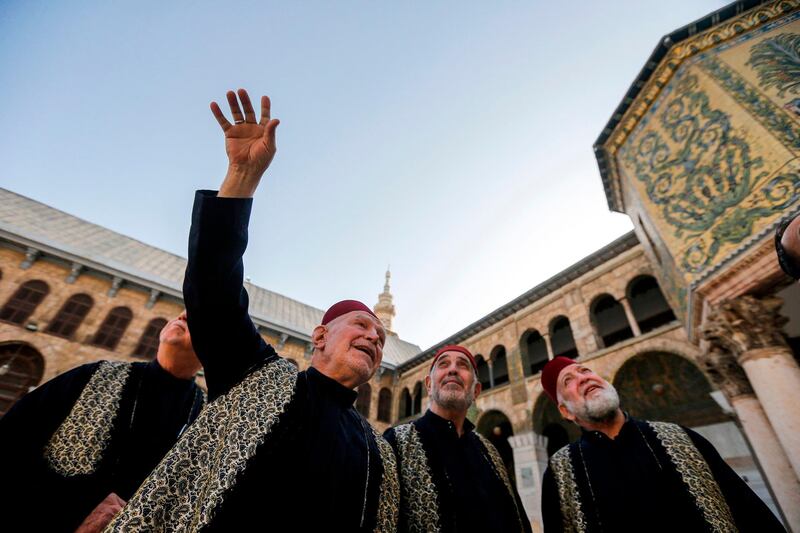 Mohammad Ali Al Sheikh, the eldest of the Muezzins who call Muslims to prayer at the mosque, tours with fellow muezzins at the Umayyad Mosque in the ancient quarters of Damascus. AFP