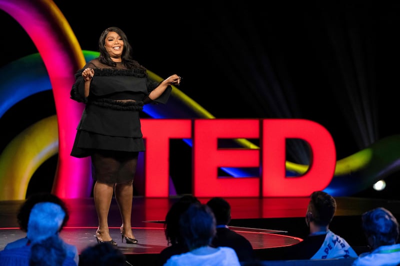 Lizzo wears a smart black mid-length dress with heels to speak at TEDMonterey on August 3, 2021. AFP