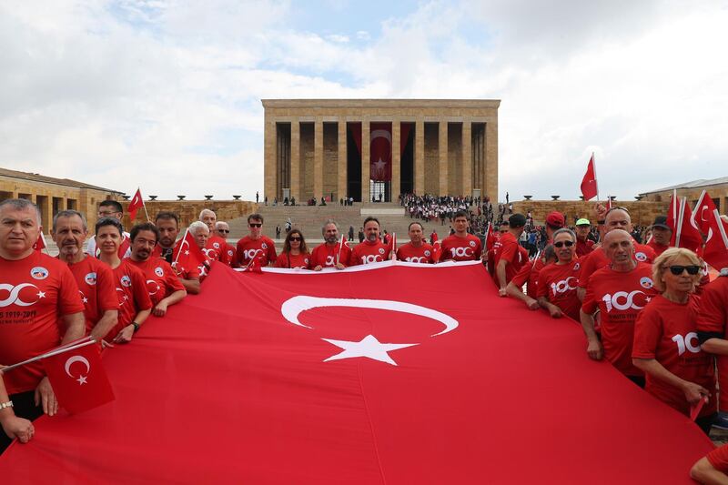 People hold a Turkish flag as they visit Anitkabir, Mustafa Kemal Ataturk’s mausoleum, to mark the 100th anniversary of May 19th Commemoration of Ataturk in Ankara.   AFP