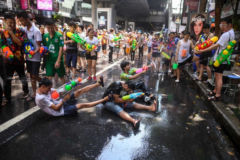 Revellers use water guns to spray at one another as they celebrate the Buddhist New Year, locally known as Songkran, in Bangkok. AFP