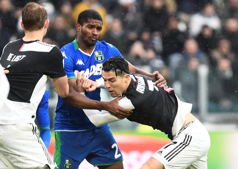 Juventus' Cristiano Ronaldo in action with Sassuolo's Marlon. Reuters