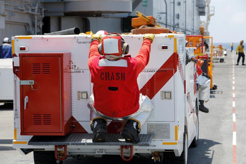 A fire fighter rides on the back of his truck on the deck of the USS Kearsarge as the vessel handles some of the evacuation of US military personnel from the US Virgin Islands in advance of Hurricane Maria, in the Caribbean Sea. Jonathan Drake / Reuters