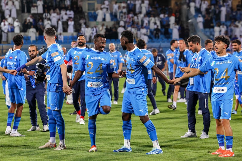 Al Hilal's players celebrate their SPL title victory on the pitch after the win against Al Hazm. AFP