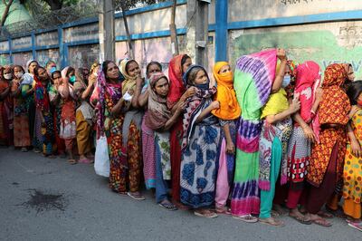 Women stand in a queue to receive relief supplies provided by local community amid the coronavirus disease (COVID-19) outbreak in Dhaka, Bangladesh, April 1, 2020. REUTERS/Mohammad Ponir Hossain