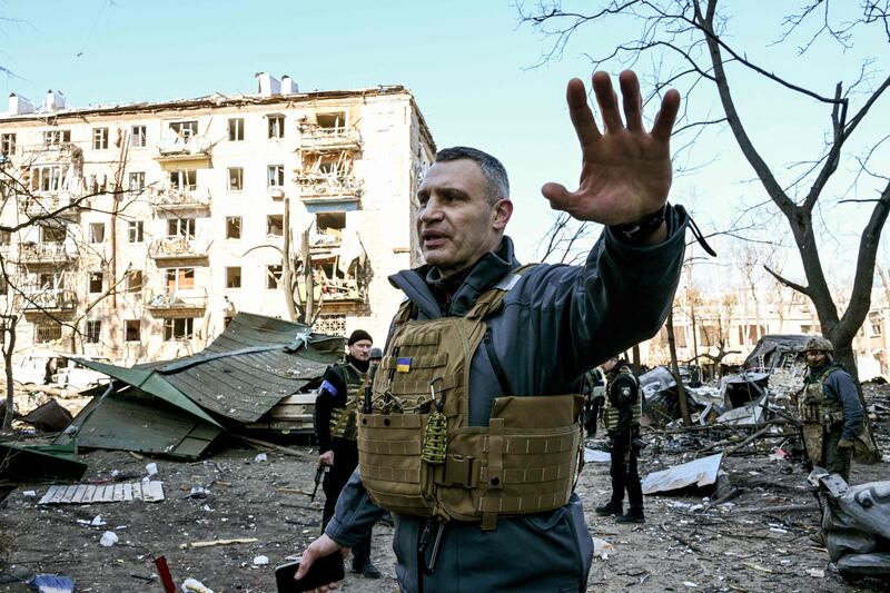 Kyiv's mayor Vitali Klitschko keeps people away from a five-storey residential building that partially collapsed after shelling on March 18. AFP