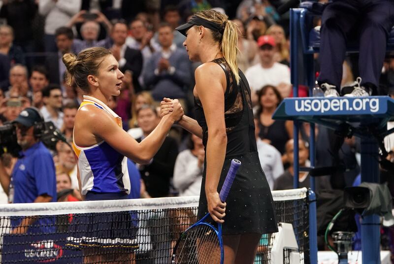 Maria Sharapova and Simona Halep shake hands at the net after the Russian's victory. Don Emmert / AFP