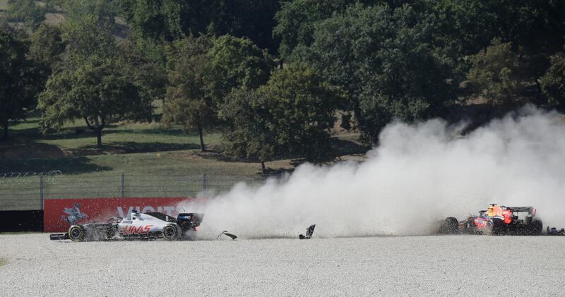 Haas' Romain Grosjean and Red Bull's Max Verstappen after crashing at the start of the Tuscan Grand Prix. Reuters