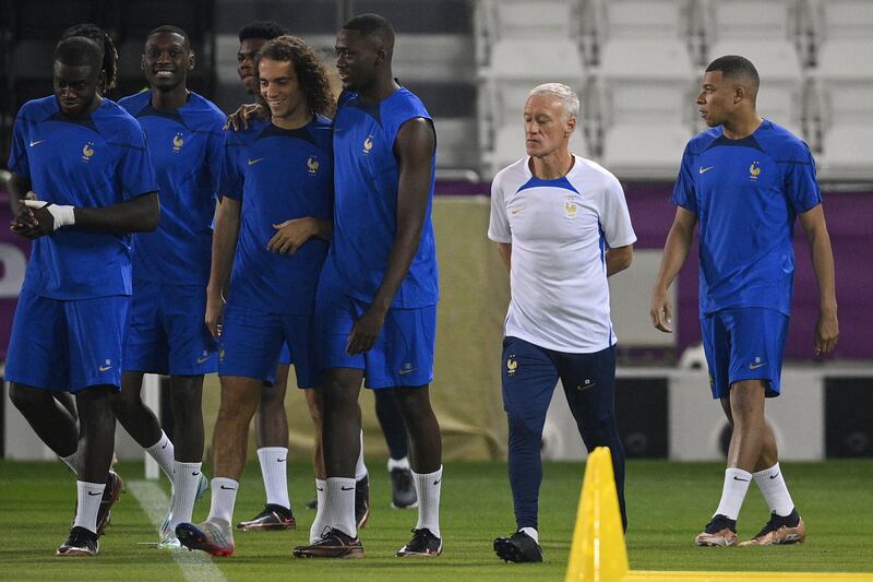 France's coach Didier Deschamps oversees a training session of his players including France's forward Kylian Mbappe (R) at the Al Janoub stadium in Al-Wakrah / Al Sadd SC Training site in Doha, on November 21, 2022, on the eve of the Qatar 2022 World Cup football match between France and Australia.  (Photo by FRANCK FIFE  /  AFP)