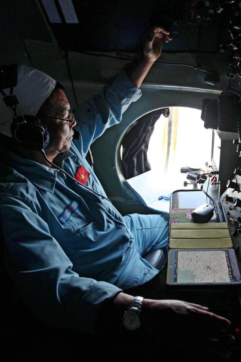 A military official looks out a window in search for Malaysia Airlines flight MH370. Luong Thai Linh / EPA March 10