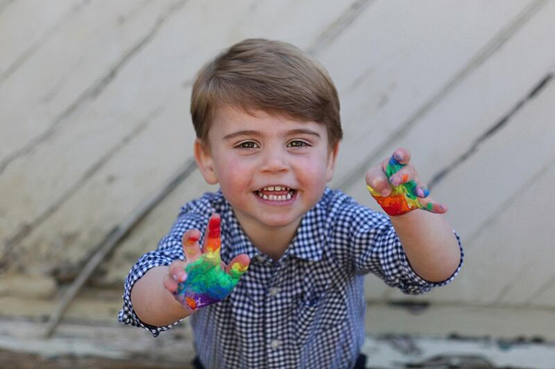 The photos taken by his mother, Kate the Duchess of Cambridge, show he rainbow-painted hands after making the artwork. The Duchess of Cambridge