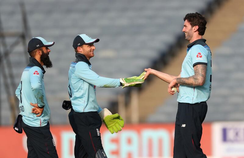 England's Reece Topley, right, celebrates with teammates the dismissal of India's Hardik Pandya. AP