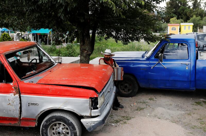 A musician waits to play at the San Lorenzo Tezonco cemetery in Mexico City, Mexico. Reuters