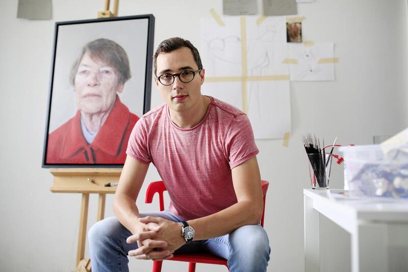 Dubai-based artist Edward Sutcliffe is photographed with his painting of Glenda Jackson in his home studio. Sarah Dea / The National