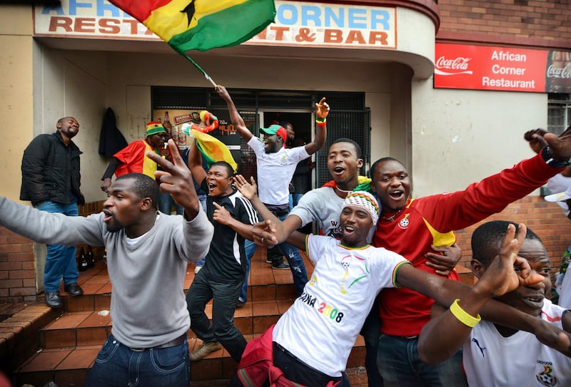 NOT FOR RESALE
JOHANNESBURG - 20130120 - Ghana-supporters komen vierend de kroeg African Corner in Yeoville, Johannesburg, uit rennen, nadat Ghana de 2-0 maakt tegen Congo. 
Photo: Bram Lammers 
NOT FOR RESALE.
COPYRIGHT BRAM LAMMERS PHOTOGRAPHY
