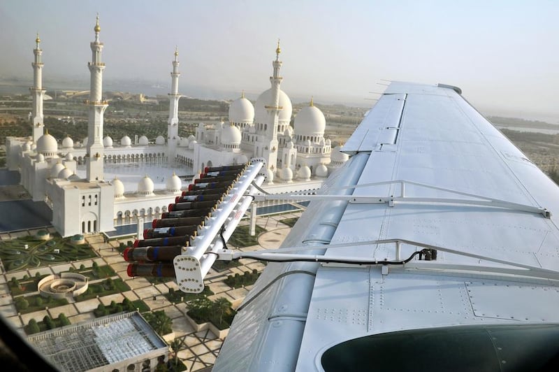 A National Centre for Meteorology and Seismology cloud-seeding plane flies over the Sheikh Zayed Mosque in Abu Dhabi. Courtesy National Centre for Meteorology and Seismology